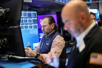 FILE PHOTO: Traders work on the floor at the New York Stock Exchange (NYSE) in New York City, U.S., December 10, 2024.  REUTERS/Brendan McDermid/File Photo